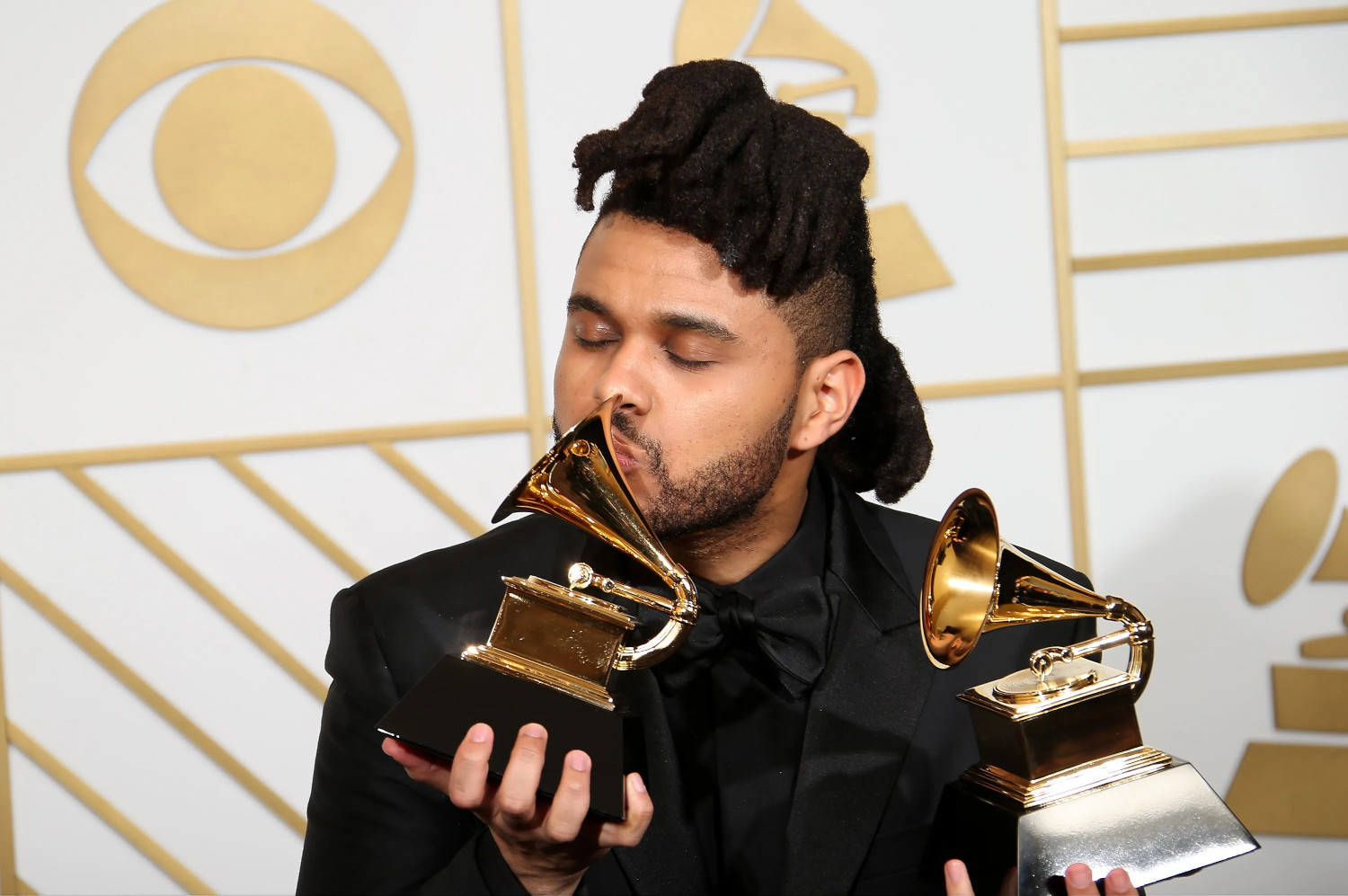 The Weeknd at the 58th GRAMMY Awards on February 15, 2016 in Los Angeles, California. The CBS all-seeing eye watching over his shoulder.