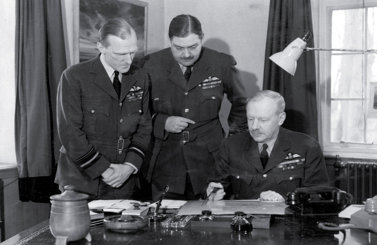 Arthur Travers Harris ('Bomber Harris') with staff members C. Graham and Robert Saundby at Bomber Command HQ in High Wycombe on 15 May 1942