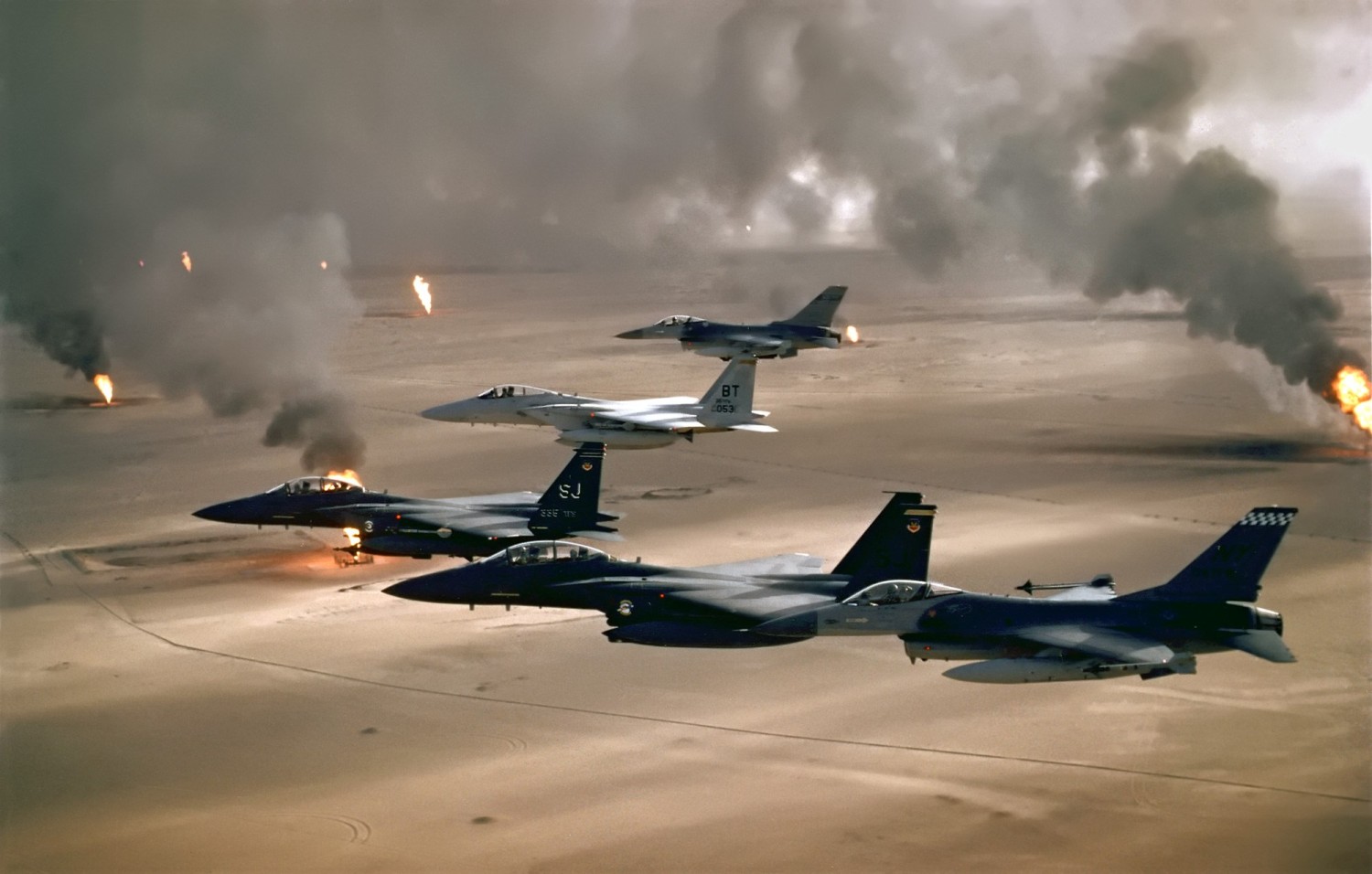 USAF aircrafts fly over burning Kuwaiti oil wells during Operation Desert Storm, 1991