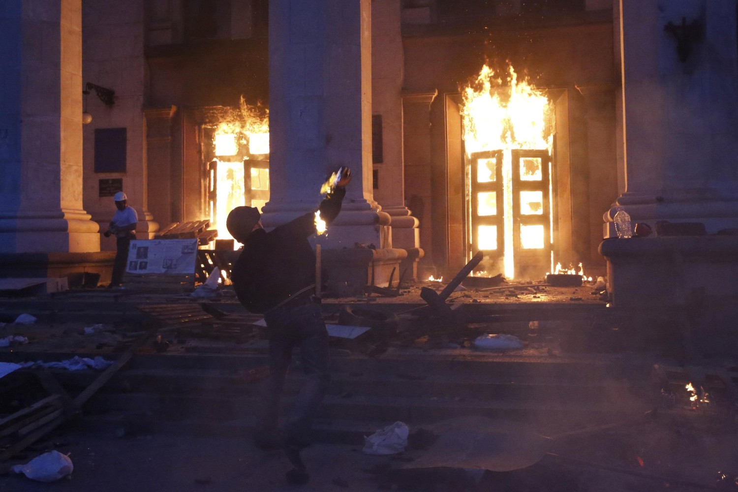 A protester throws a Molotov cocktail at the Trade Unions Building in Odessa