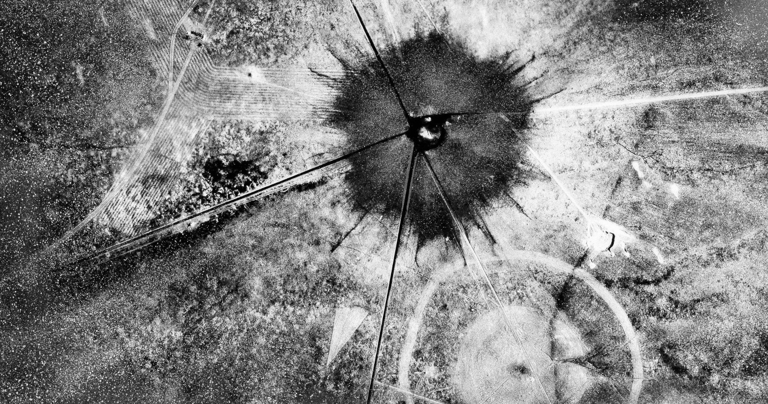 An aerial view of the aftermath of the first atomic explosion at the Trinity test site in New Mexico in 1945. The device exploded with a power equivalent to 21,000 tons of TNT.