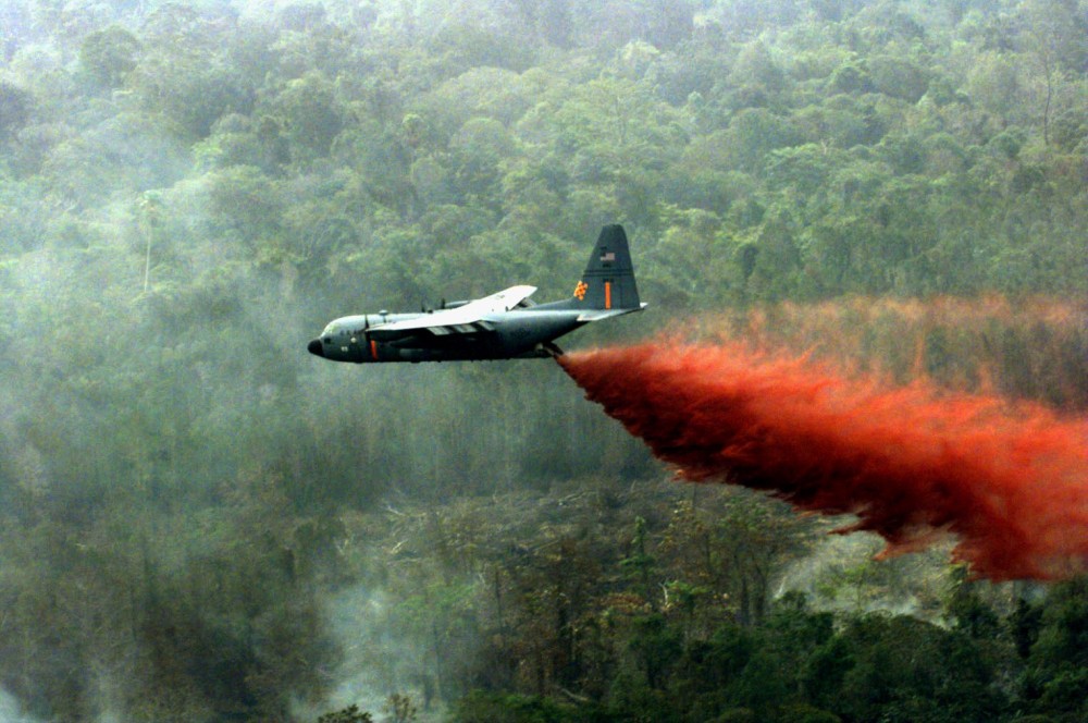 An American aircraft sprays the potent chemical, known as Agent Orange, over the dense Vietnamese jungle